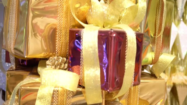 Pile of present gift boxes wrapped in golden shiny paper in holiday celebration festival such as Christmas time