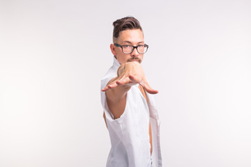 Expression and gesture concept - Young man in white shirt with his hand forward to camera