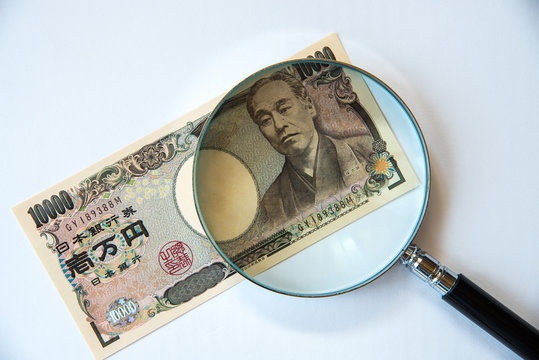 Japanese 10K Bank Note Under Magnifying Glass