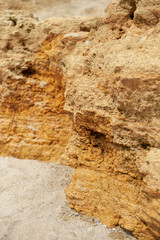 closeup of stone on the beach, sea coast with high hills, beautiful wild landscape