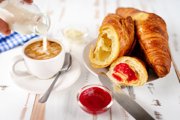 Breakfast with cup of coffee and croissants