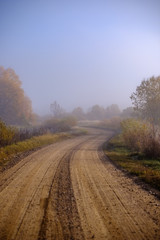 Fototapeta na wymiar country gravel road in autumn colors in fall colors