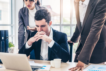 Businessman worry about his job with serious boss discussing while commenting a financial report...