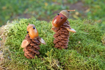 Figures made of acorns and cones