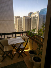 Fototapeta premium Vertical shot of a beautiful relaxing balcony with plants view from a tower in the city