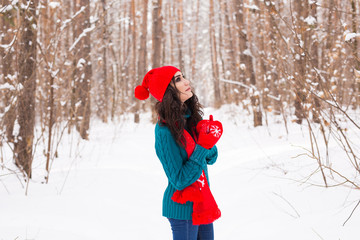 Happy young woman walking in winter time. Pretty girl in snowy nature