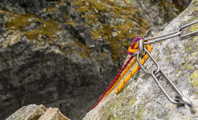Climbing rope postponed by a rappel stance, prepared for descent from the summit.