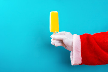 santa claus holding a popsicle in front of a blue background