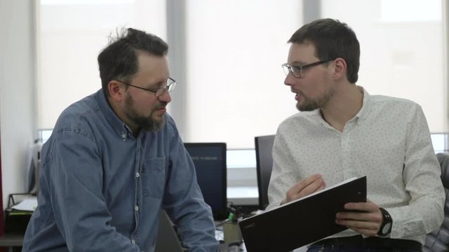 Two businessmen talking in office