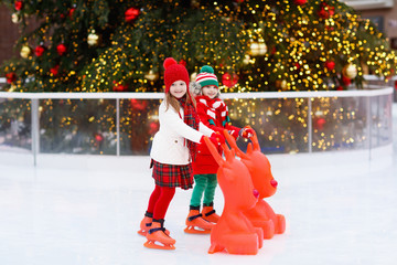 Kids ice skating in winter. Ice skates for child.