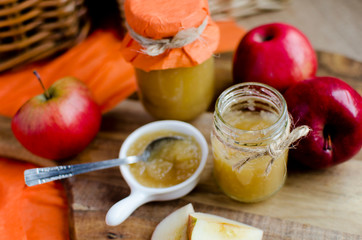 Homemade apple jam in the jar on the wooden table