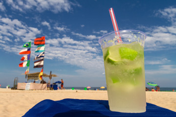 Glass with caipirinha on the beach of Copacabana (Rio de Janeiro, Brazil)