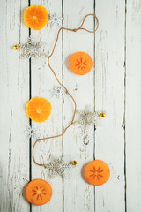 White wooden background with christmas decoration and fruits pieces