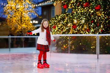 Kids ice skating in winter. Ice skates for child.