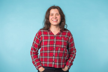 Obraz premium Emotions and people concept - beautiful young woman smiling over blue background