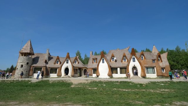 Beautiful fairy's castle Romania, blue serene sky and green grass