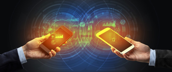 Close up of two smartphones syncing business data