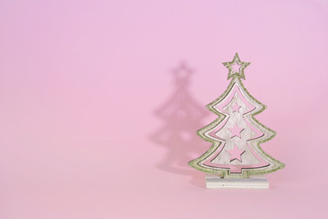 Christmas wooden tree over light blue background.