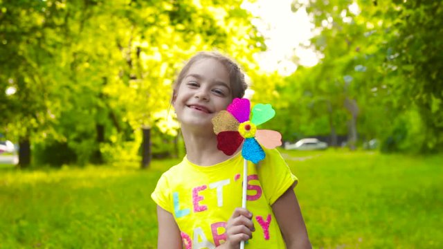 Girl holding colorful pinwheel