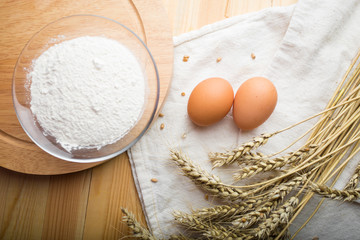 kitchen still life from flour, wheat ears and eggs