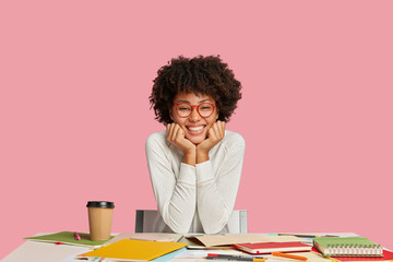 Glad ethnic wonk wears glasses, has toothy smile, prepares for upcoming exam, spends time on...