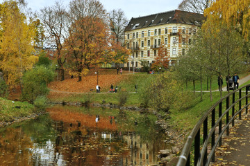 Fototapeta na wymiar Walking path along the river in city in autumn. River Akerselva in Oslo, Norway.