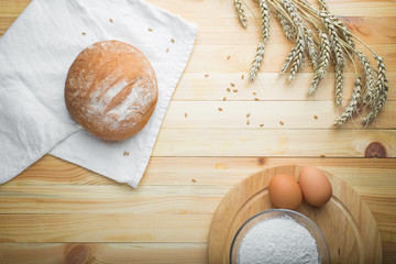 kitchen still life from flour, wheat ears, bread and eggs