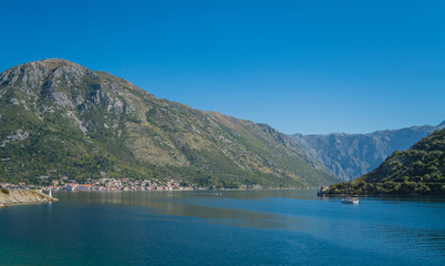 Mediterranean Landscape with Sailboat sailing in Bay of Kotor, Adriatic Sea, Montenegro
