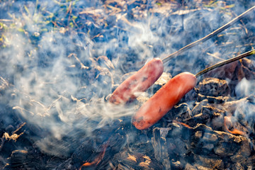 Fototapeta na wymiar sausages are fried over coals