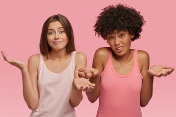 Clueless hesitant women with uncertain expressions, smirk and frown faces, can not make opinion...