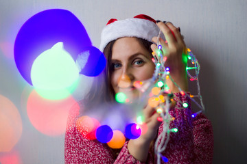 beautiful young woman with shining garland lights