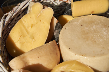 Different varieties of craft cheese in a wicker basket