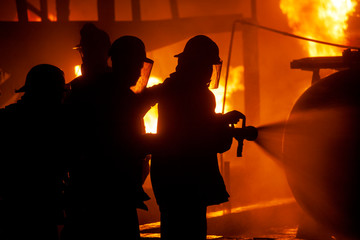 JOHANNESBURG, SOUTH AFRICA - OCTOBER, 2018 Firefighters spraying down fire during firefighting training exercise