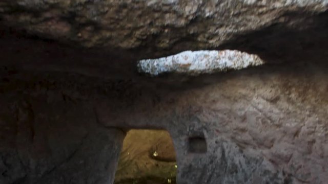 Ancient cave with door. Shot. Interior with hearth of ancient room in cave. Out of the old caves, stone walls. Out of the old caves, stone walls.