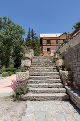 Stone stairs going to a beautiful building surrounded by trees and flower in Mendoza Argentina