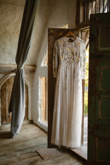 dress hanging from a door in old french cottage