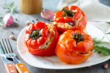 Stuffed Pepper with Rice, Tomatoes and Beans on a stone or concrete background. Vegetarian Healthy...