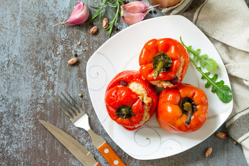 Stuffed Pepper with Rice, Tomatoes and Beans on a stone or concrete background. Vegetarian Healthy Food. Top view flat lay background.
