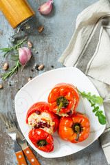 Stuffed Pepper with Rice, Tomatoes and Beans on a stone or concrete background. Vegetarian Healthy Food. Top view flat lay background. Copy space.