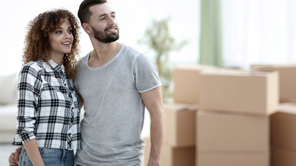 Happy couple standing in new living room