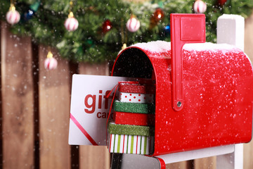 Red mailbox with Christmas gift card and presents