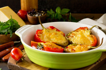 Stuffed peppers with turkey meat and cheese on a wooden table. Healthy food. Copy space.
