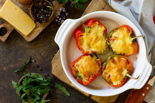Stuffed peppers with turkey meat and cheese on a wooden table. Healthy food. Top view flat lay background. Copy space.