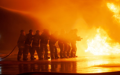 JOHANNESBURG, SOUTH AFRICA - OCTOBER, 2018 Firefighters spraying down fire during firefighting...