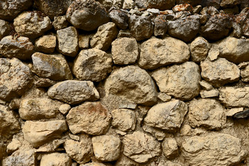 The texture of an ancient destroyed stone wall. The masonry of the 14th century. 