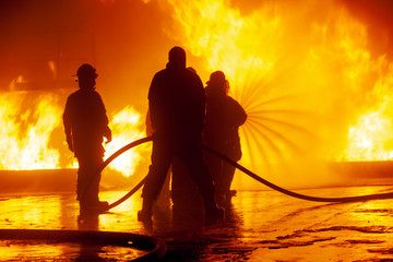 JOHANNESBURG, SOUTH AFRICA - OCTOBER, 2018 Firefighters spraying down fire during firefighting...