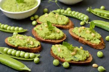 Vegeterian food. Sandwiches with green pea puree and pine nuts.