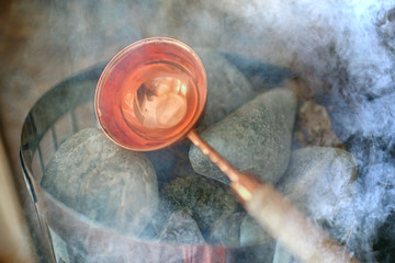sauna stones / hot stones for water supply, steam on the stones in the sauna, spa concept, hot...
