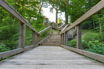 Fototapeta na wymiar Bridge and stairs leading out of a nature walk