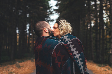 Fototapeta premium Young hipster couple in love with in the forest